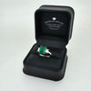 Emerald Ring with Emerald Cut Diamond Side Stones Set in 18ct White Gold