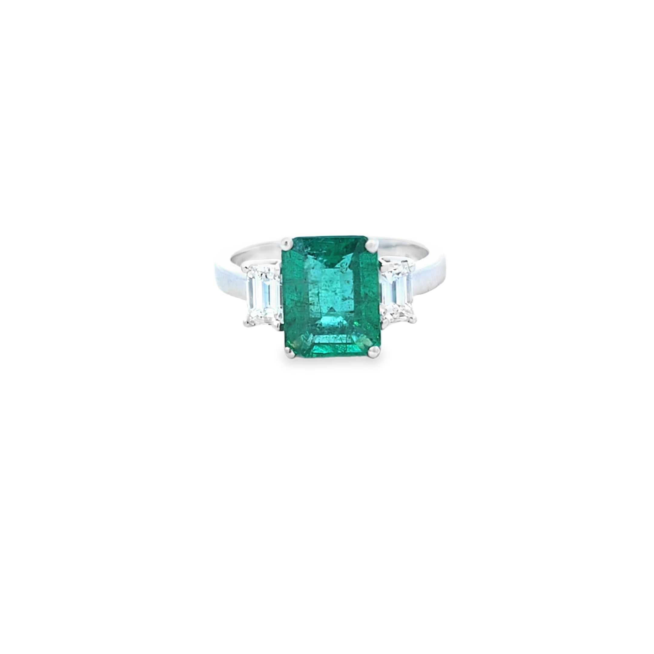 Emerald Ring with Emerald Cut Diamond Side Stones Set in 18ct White Gold