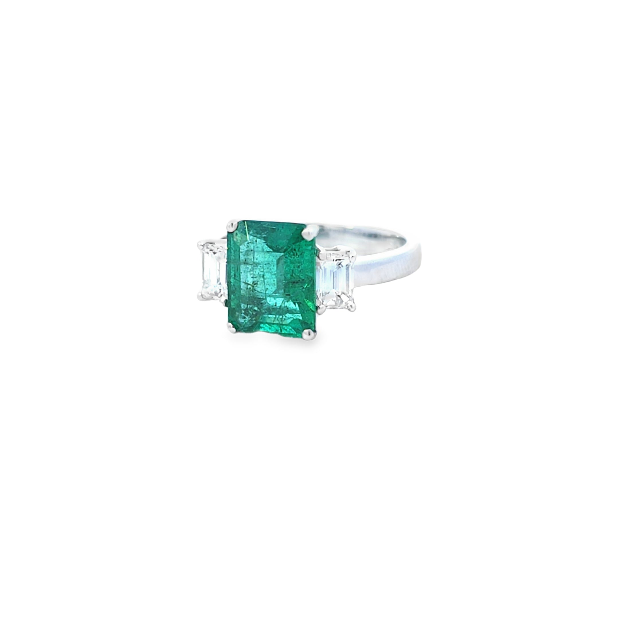 Emerald Ring with Emerald Cut Diamond Side Stones Set in 18ct White Gold