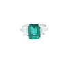 Emerald Ring with Emerald Cut Diamond Side Stones Set in 18ct White Gold