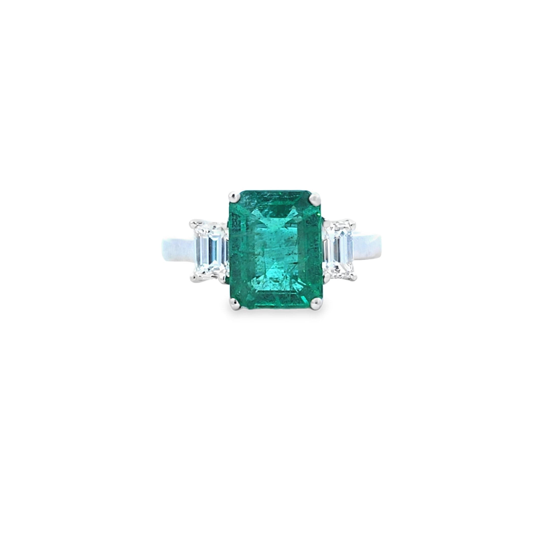 Emerald Ring with Emerald Cut Diamond Side Stones Set in 18ct White Gold