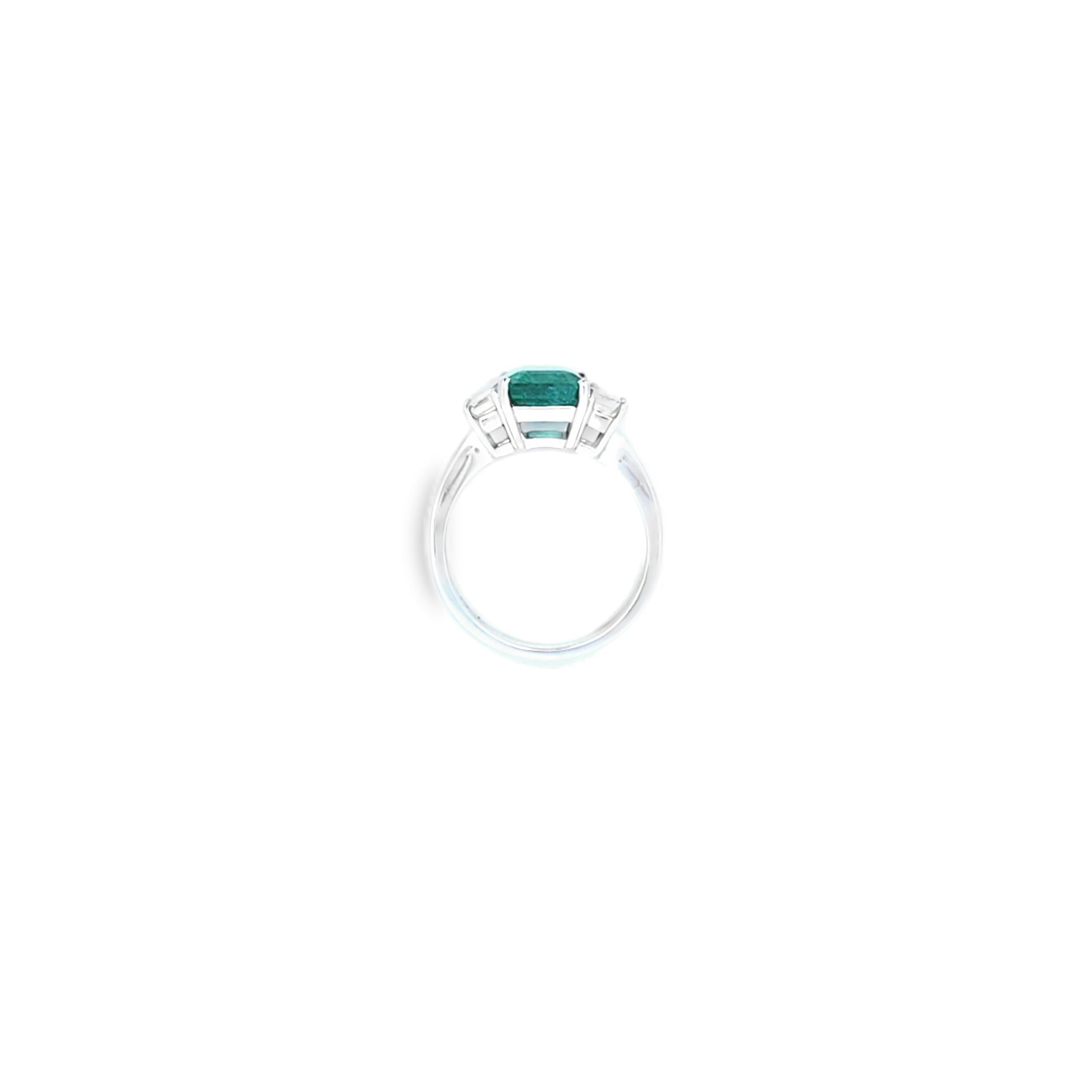 Emerald Ring with Emerald Cut Diamond Side Stones Set in 18ct White Gold